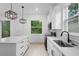 Bright kitchen with black faucet, white cabinets and stainless steel sink at 2137 Brighton Ln, Orlando, FL 32817
