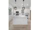 Modern, all-white kitchen with stainless appliances, modern light fixtures, and a center island at 2137 Brighton Ln, Orlando, FL 32817