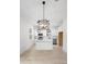 Modern, all-white kitchen with stainless appliances, modern light fixtures, and a center island at 2137 Brighton Ln, Orlando, FL 32817
