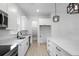 Bright kitchen with stainless steel sink, island, and white cabinets at 2137 Brighton Ln, Orlando, FL 32817