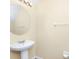 A pedestal sink with an oval mirror are the focal points of this classic half bathroom at 2157 Cypress Villas Dr, Orlando, FL 32825