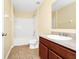 Bathroom with tub and shower, vanity with wood cabinets and neutral countertop at 2157 Cypress Villas Dr, Orlando, FL 32825