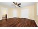 Bright bedroom featuring gleaming floors, ceiling fan, ensuite bathroom, and large closet at 2157 Cypress Villas Dr, Orlando, FL 32825