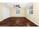 Inviting bedroom offers hardwood floors, ceiling fan, closet and two windows at 2157 Cypress Villas Dr, Orlando, FL 32825