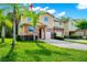 Charming townhome featuring a stone facade, two-car garage, and well-manicured landscaping at 2157 Cypress Villas Dr, Orlando, FL 32825