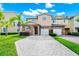 Charming townhome featuring a stone facade, two-car garage, and well-manicured landscaping at 2157 Cypress Villas Dr, Orlando, FL 32825