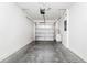 Clean, empty garage with modern door, gray floor, and water conditioner at 2157 Cypress Villas Dr, Orlando, FL 32825