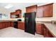 Well-equipped kitchen with dark wood cabinets, black appliances, and tiled flooring at 2157 Cypress Villas Dr, Orlando, FL 32825
