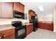 Well-equipped kitchen with dark wood cabinets, black appliances, and tiled flooring at 2157 Cypress Villas Dr, Orlando, FL 32825