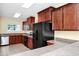 Well-equipped kitchen with dark wood cabinets, black appliances, and tiled flooring at 2157 Cypress Villas Dr, Orlando, FL 32825