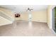 Spacious living room features tile flooring, ceiling fan, and sliding glass door to the backyard at 2157 Cypress Villas Dr, Orlando, FL 32825