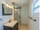 Bathroom featuring shower with glass door, dark wood vanity, and decorative tiling at 2171 Chippewa Trl, Maitland, FL 32751