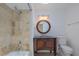 Cozy bathroom features a granite vanity, decorative mirror and a shower with decorative tiles at 2171 Chippewa Trl, Maitland, FL 32751