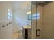 Bathroom with a glass-enclosed shower, dark wood vanity, and neutral color scheme at 2171 Chippewa Trl, Maitland, FL 32751