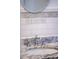Close up of a bathroom with a round mirror, marble countertops, and decorative tiles at 2171 Chippewa Trl, Maitland, FL 32751