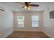 Bedroom featuring laminate floors, ceiling fan, and two bright windows at 2171 Chippewa Trl, Maitland, FL 32751