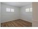 Inviting bedroom featuring modern vinyl flooring, natural light from windows with shutters, and neutral decor at 2171 Chippewa Trl, Maitland, FL 32751
