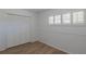 Cozy bedroom featuring wood floors, white walls, and a shuttered window at 2171 Chippewa Trl, Maitland, FL 32751