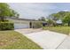 Exterior shot of home with attached garage and front yard featuring lush lawn and decorative concrete details at 2171 Chippewa Trl, Maitland, FL 32751