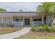 Inviting home entrance with decorative concrete screen, manicured landscaping, and a stylish front door at 2171 Chippewa Trl, Maitland, FL 32751