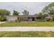 Charming front exterior with decorative concrete screen walls, lush landscaping, and well-kept lawn at 2171 Chippewa Trl, Maitland, FL 32751
