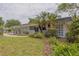 Landscaped front yard with decorative concrete screen walls and a well-maintained lawn at 2171 Chippewa Trl, Maitland, FL 32751
