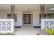 A welcoming front porch featuring decorative concrete screen walls and an elegant glass front door at 2171 Chippewa Trl, Maitland, FL 32751