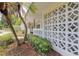 Charming front porch with a decorative breeze block wall and lush landscaping at 2171 Chippewa Trl, Maitland, FL 32751