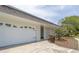 Attached garage featuring a white garage door, decorative concrete screen and well-maintained lawn at 2171 Chippewa Trl, Maitland, FL 32751