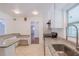 Bright kitchen featuring white cabinets, stainless steel appliances, granite countertops and desk area at 2171 Chippewa Trl, Maitland, FL 32751