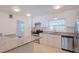 Bright kitchen with white cabinets, granite countertops, stainless steel appliances, and tile flooring at 2171 Chippewa Trl, Maitland, FL 32751