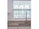 Close up of a kitchen featuring modern faucet fixtures and a window with decorative concrete block at 2171 Chippewa Trl, Maitland, FL 32751
