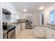 Bright kitchen with stainless steel appliances, granite countertops, and white cabinetry at 2171 Chippewa Trl, Maitland, FL 32751