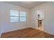 Cozy room with hardwood floors, bright window, and an open doorway view to kitchen, perfect blend of style and functionality at 2171 Chippewa Trl, Maitland, FL 32751