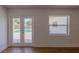 A bright living room with a view of the pool through French doors and a window at 2171 Chippewa Trl, Maitland, FL 32751