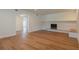 Spacious living room with hardwood floors, a stone fireplace, and an open layout, ideal for entertaining and relaxation at 2171 Chippewa Trl, Maitland, FL 32751