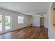 Bright living room with wood-look floors, white walls, and plenty of natural light from doors and windows at 2171 Chippewa Trl, Maitland, FL 32751