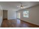 An empty living room features a large door leading to a pool and a ceiling fan at 2171 Chippewa Trl, Maitland, FL 32751