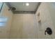 A modern shower with stone accents and a rainfall shower head at 2171 Chippewa Trl, Maitland, FL 32751