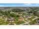 Beautiful aerial view of a home with a well-maintained yard and mature trees in a quiet residential neighborhood at 2316 Irlo Dr, Kissimmee, FL 34741