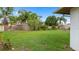 Spacious backyard featuring lush green grass and a privacy fence at 2316 Irlo Dr, Kissimmee, FL 34741