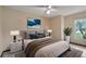 Cozy bedroom with neutral tones, ceiling fan, and large window offering natural light at 2316 Irlo Dr, Kissimmee, FL 34741
