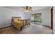 Bedroom with a ceiling fan, neutral carpet, and glass slider access to the backyard at 2316 Irlo Dr, Kissimmee, FL 34741