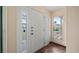 Bright foyer with a white door and sidelights, tile flooring, and view to outdoors at 2316 Irlo Dr, Kissimmee, FL 34741
