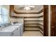 Laundry room with storage shelving, tile floors, and washer/dryer hookups at 2316 Irlo Dr, Kissimmee, FL 34741