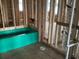 Framing of a bathroom with a teal bathtub and plumbing at 2383 Zuni Road, St Cloud, FL 34771