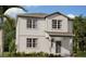 Charming two-story home with gray siding, manicured landscaping, and a welcoming front entrance at 2383 Zuni Road, St Cloud, FL 34771