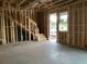 Unfinished interior reveals an open floor plan, wooden framing, staircase, and concrete slab flooring at 2383 Zuni Road, St Cloud, FL 34771