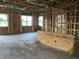 Unfinished interior reveals exposed wooden framing, concrete floor, and open stud bays for future construction at 2383 Zuni Road, St Cloud, FL 34771