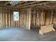 Interior view features exposed wooden framing, a concrete floor, and rough-in electrical wiring at 2383 Zuni Road, St Cloud, FL 34771